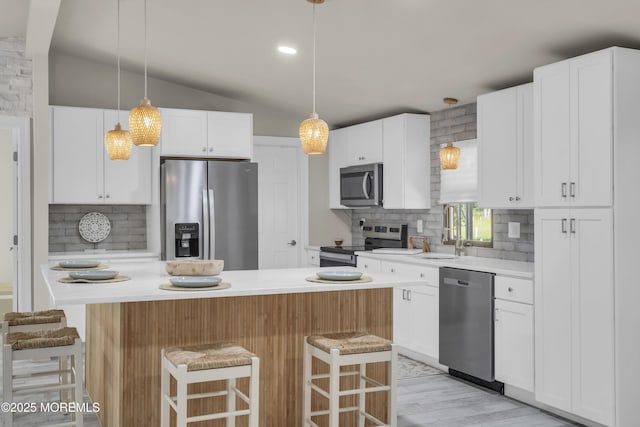 3 Casey Ct, Barnegat, NJ 08005 - kitchen with stainless steel appliances, tasteful backsplash, a kitchen bar, decorative light fixtures, and vaulted ceiling