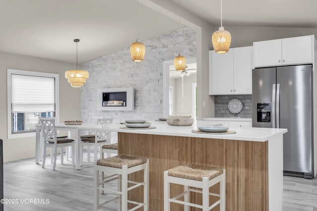 3 Casey Ct, Barnegat, NJ 08005 - kitchen with stainless steel fridge with ice dispenser, lofted ceiling, light wood-style floors, white cabinetry, and a kitchen island