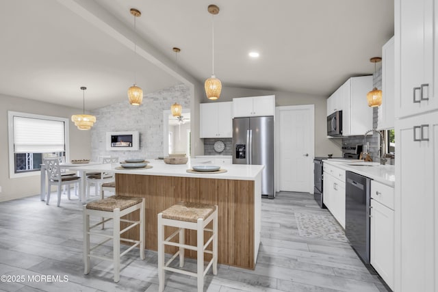 3 Casey Ct, Barnegat, NJ 08005 - kitchen with appliances with stainless steel finishes, vaulted ceiling, a breakfast bar, backsplash, and a kitchen island