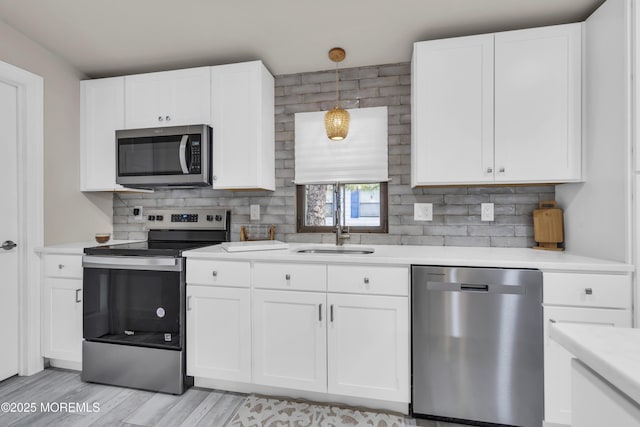 3 Casey Ct, Barnegat, NJ 08005 - kitchen with stainless steel appliances, light countertops, decorative backsplash, and white cabinets
