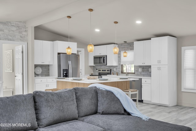 3 Casey Ct, Barnegat, NJ 08005 - kitchen featuring stainless steel appliances, open floor plan, decorative backsplash, light wood finished floors, and white cabinets