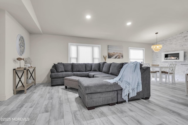 3 Casey Ct, Barnegat, NJ 08005 - living area featuring light wood finished floors, a stone fireplace, and lofted ceiling