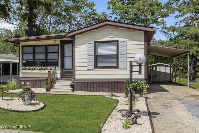 3 Casey Ct, Barnegat, NJ 08005 - manufactured / mobile home with a front lawn, concrete driveway, and a shed