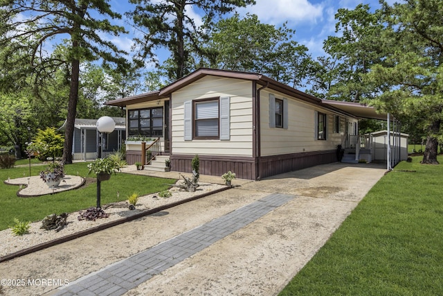 3 Casey Ct, Barnegat, NJ 08005 - manufactured / mobile home featuring a front yard, driveway, and an attached carport