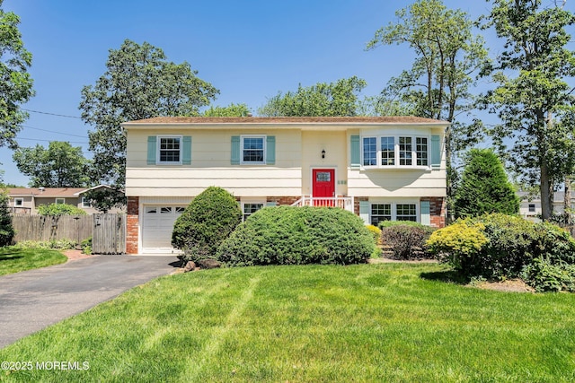 235 Long Branch Ave, Bayville, NJ 08721 - split foyer home with asphalt driveway, brick siding, and a garage