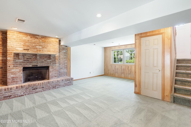 235 Long Branch Ave, Bayville, NJ 08721 - unfurnished living room featuring stairway, light colored carpet, a fireplace, recessed lighting, and wood walls