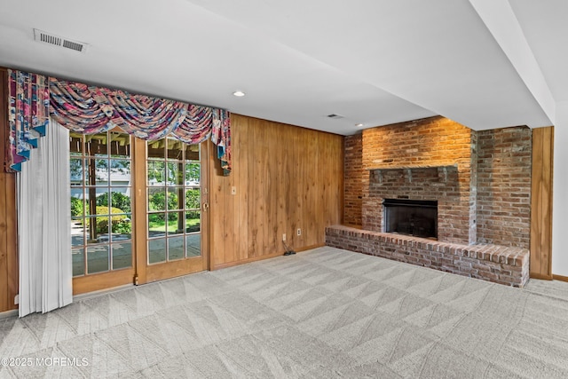 235 Long Branch Ave, Bayville, NJ 08721 - unfurnished living room with carpet, wooden walls, a brick fireplace, and recessed lighting