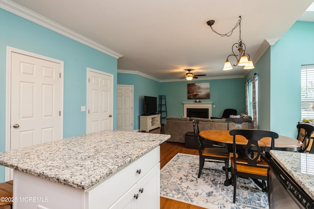 96 Bridle Path, Bayville, NJ 08721 - kitchen featuring ornamental molding, dark wood finished floors, a fireplace, ceiling fan, and white cabinetry