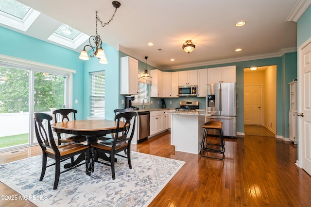 96 Bridle Path, Bayville, NJ 08721 - dining room featuring a skylight, dark wood finished floors, crown molding, and recessed lighting