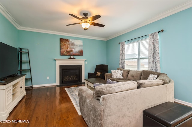 96 Bridle Path, Bayville, NJ 08721 - living area with ornamental molding, dark wood-type flooring, ceiling fan, and a fireplace with flush hearth