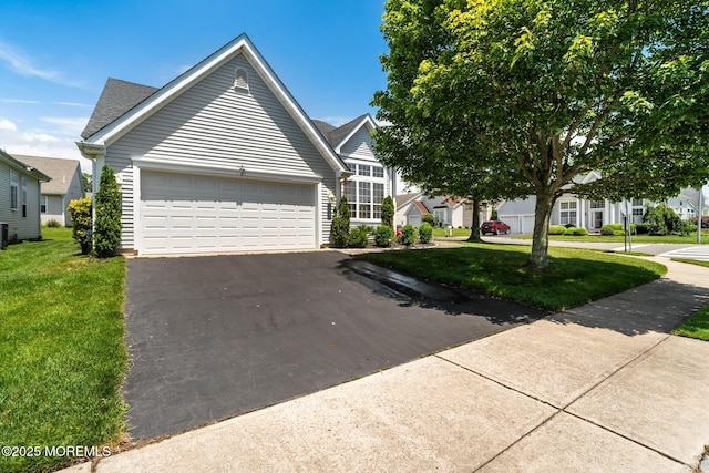 57 Mirage Blvd, Barnegat, NJ 08005 - view of front of house featuring asphalt driveway, a front yard, and an attached garage