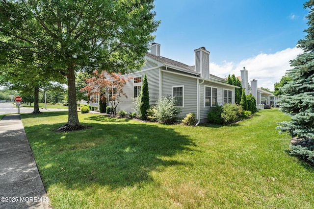 57 Mirage Blvd, Barnegat, NJ 08005 - view of home's exterior featuring a yard and a chimney