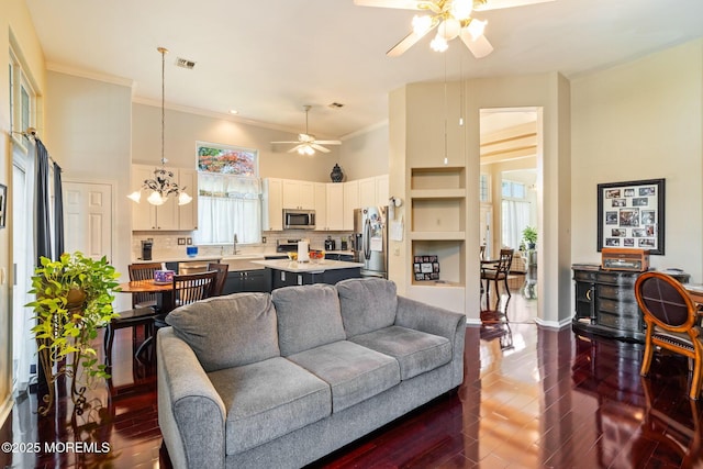 57 Mirage Blvd, Barnegat, NJ 08005 - living area featuring ceiling fan, a towering ceiling, dark wood-type flooring, ornamental molding, and a chandelier