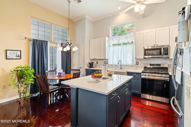 57 Mirage Blvd, Barnegat, NJ 08005 - kitchen with stainless steel appliances, light countertops, dark wood finished floors, a ceiling fan, and white cabinets