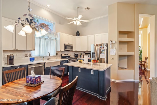 57 Mirage Blvd, Barnegat, NJ 08005 - kitchen featuring appliances with stainless steel finishes, dark wood-style flooring, ceiling fan, white cabinetry, and a center island