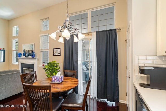 57 Mirage Blvd, Barnegat, NJ 08005 - dining room featuring dark wood finished floors, a chandelier, and a fireplace