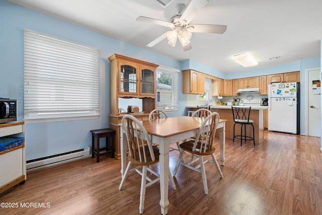 188 Lions Head Blvd S, Brick, NJ 08723 - dining area with baseboard heating, light wood-type flooring, and a ceiling fan