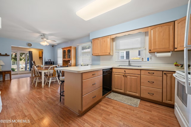188 Lions Head Blvd S, Brick, NJ 08723 - kitchen featuring a peninsula, white electric range oven, light wood-style flooring, a breakfast bar area, and light countertops