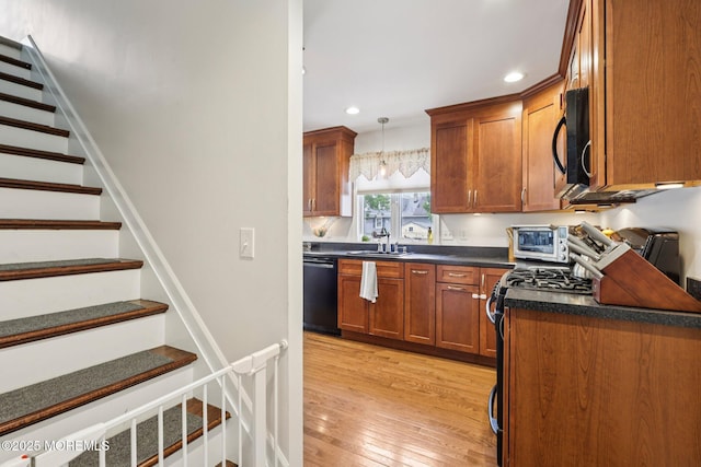 98 Washington St, Keyport, NJ 07735 - kitchen with black appliances, dark countertops, recessed lighting, light wood-style flooring, and pendant lighting