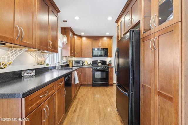 98 Washington St, Keyport, NJ 07735 - kitchen with black appliances, light wood-style floors, brown cabinets, dark countertops, and recessed lighting