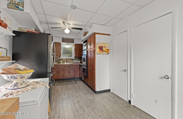 517 Laurel Ave, West Allenhurst, NJ 07711 - kitchen featuring a drop ceiling, a ceiling fan, light wood finished floors, stainless steel appliances, and brown cabinetry