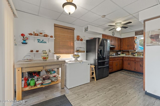 517 Laurel Ave, West Allenhurst, NJ 07711 - kitchen with stainless steel refrigerator with ice dispenser, brown cabinetry, a ceiling fan, light wood finished floors, and a paneled ceiling