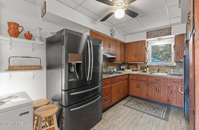 517 Laurel Ave, West Allenhurst, NJ 07711 - kitchen featuring stainless steel fridge, a drop ceiling, light wood-style floors, brown cabinets, and a ceiling fan