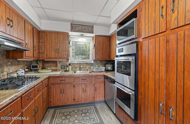 517 Laurel Ave, West Allenhurst, NJ 07711 - kitchen featuring stainless steel appliances, a drop ceiling, brown cabinetry, and tasteful backsplash
