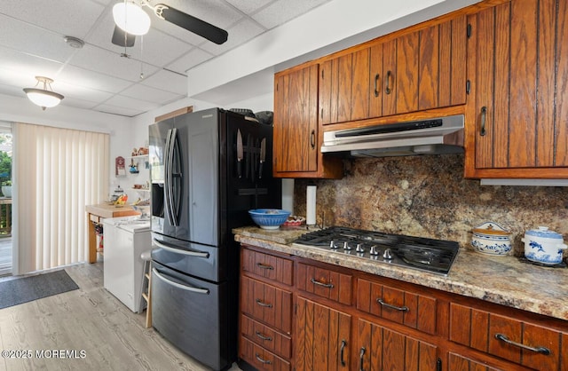 517 Laurel Ave, West Allenhurst, NJ 07711 - kitchen with stainless steel gas cooktop, under cabinet range hood, a paneled ceiling, refrigerator with ice dispenser, and light wood-style floors