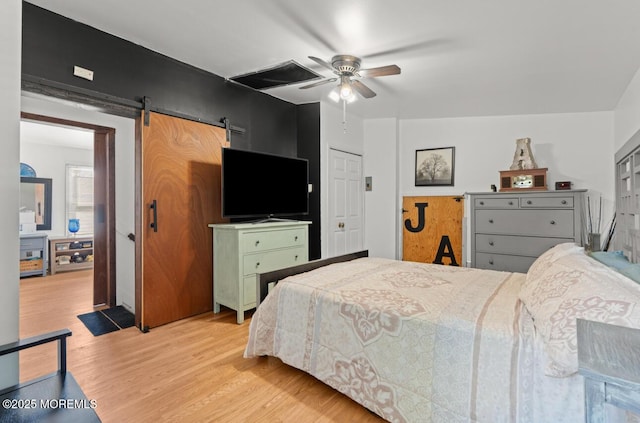 517 Laurel Ave, West Allenhurst, NJ 07711 - bedroom featuring light wood-style floors, a barn door, and a ceiling fan