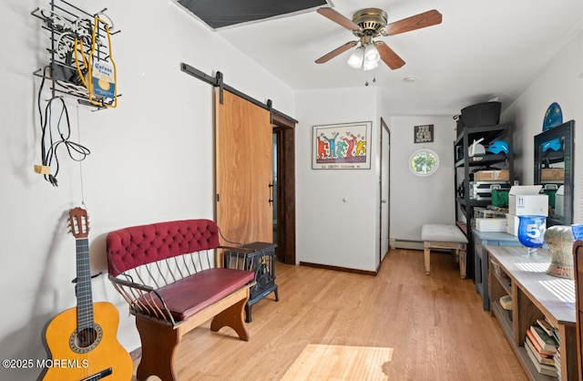 517 Laurel Ave, West Allenhurst, NJ 07711 - living area with a barn door, a ceiling fan, light wood-style floors, and a baseboard radiator