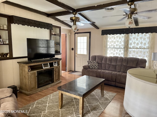 1408 Anvil Way, Toms River, NJ 08755 - living room featuring a ceiling fan, wood finished floors, beam ceiling, and a decorative wall