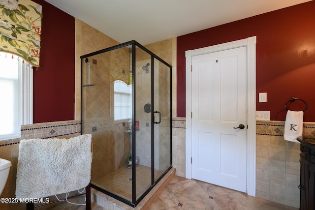 41 Cedar St, Keyport, NJ 07735 - bathroom with tile walls, plenty of natural light, a stall shower, a wainscoted wall, and tile patterned flooring