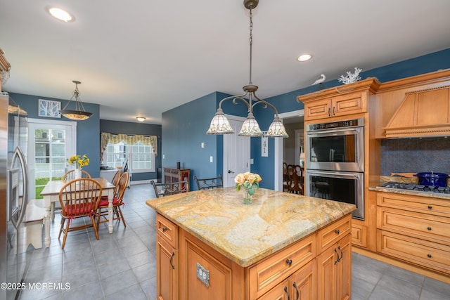 41 Cedar St, Keyport, NJ 07735 - kitchen featuring appliances with stainless steel finishes, light tile patterned flooring, light stone counters, a center island, and hanging light fixtures