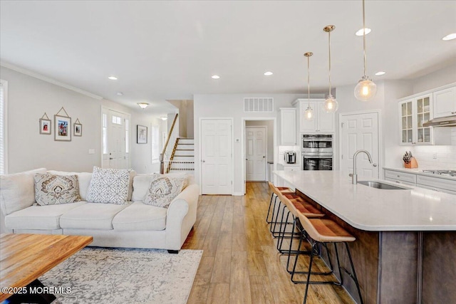 2 Lawley Dr, Lincroft, NJ 07738 - living area with recessed lighting, stairway, light wood-type flooring, and crown molding