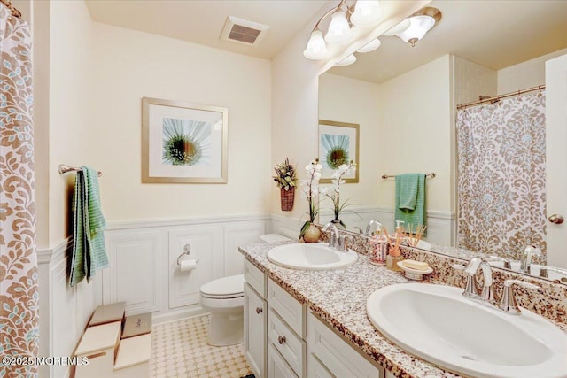 2 Lawley Dr, Lincroft, NJ 07738 - full bath featuring wainscoting, double vanity, and a shower with curtain