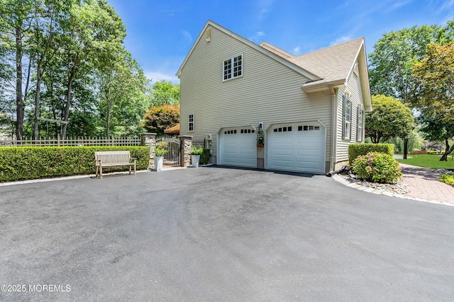 45 Erin Dr, Jackson, NJ 08527 - view of side of property featuring driveway, a garage, a gate, and roof with shingles