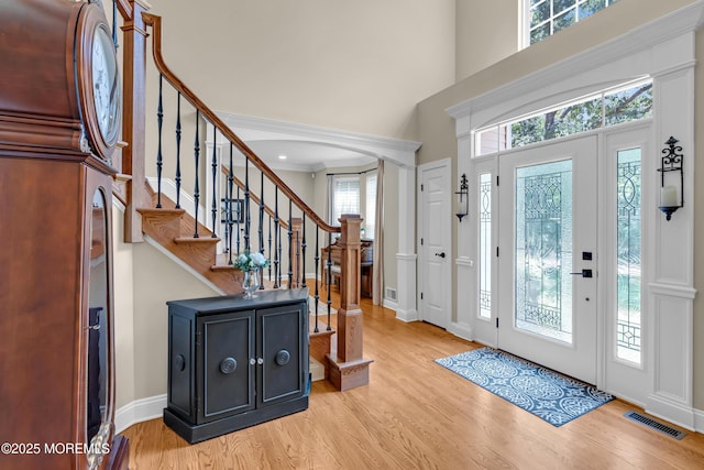 45 Erin Dr, Jackson, NJ 08527 - foyer entrance featuring light wood finished floors, arched walkways, stairs, and a towering ceiling
