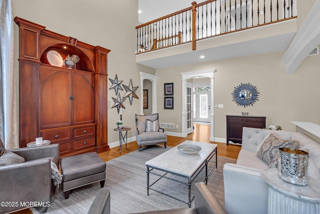 45 Erin Dr, Jackson, NJ 08527 - living room with arched walkways, light wood finished floors, a towering ceiling, and recessed lighting