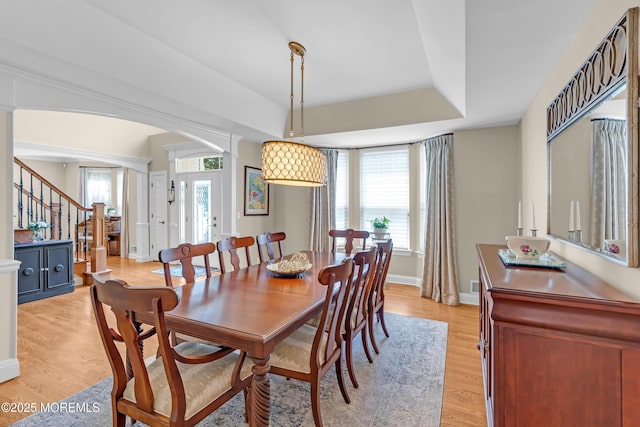45 Erin Dr, Jackson, NJ 08527 - dining room featuring light wood-style flooring, arched walkways, stairway, and a raised ceiling