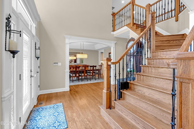 45 Erin Dr, Jackson, NJ 08527 - entrance foyer with a towering ceiling, arched walkways, stairs, wood finished floors, and healthy amount of natural light