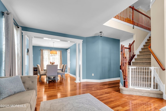 4 Queens Pass, Colts Neck, NJ 07722 - living room featuring decorative columns, stairway, and wood finished floors