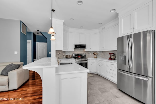 4 Queens Pass, Colts Neck, NJ 07722 - kitchen featuring stainless steel appliances, a peninsula, white cabinetry, decorative backsplash, and light countertops