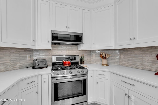 4 Queens Pass, Colts Neck, NJ 07722 - kitchen with stainless steel appliances, white cabinets, light countertops, and backsplash