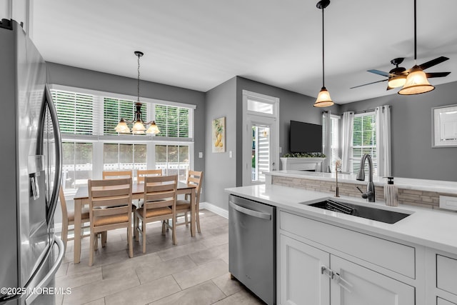 4 Queens Pass, Colts Neck, NJ 07722 - kitchen featuring appliances with stainless steel finishes, light countertops, white cabinets, a chandelier, and decorative light fixtures