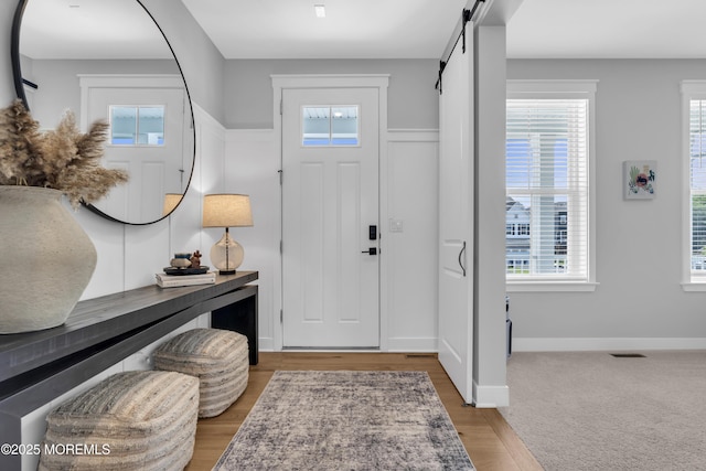 3 Devon Dr, Howell, NJ 07731 - entryway featuring a barn door, plenty of natural light, and wood finished floors