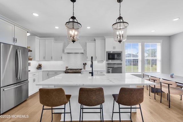 3 Devon Dr, Howell, NJ 07731 - kitchen with appliances with stainless steel finishes, tasteful backsplash, a kitchen bar, light wood-style floors, and recessed lighting
