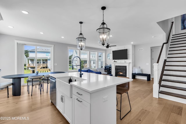 3 Devon Dr, Howell, NJ 07731 - kitchen with stainless steel dishwasher, a chandelier, light wood-style flooring, recessed lighting, and white cabinets