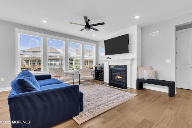 3 Devon Dr, Howell, NJ 07731 - living room featuring wood finished floors, ceiling fan, a glass covered fireplace, and recessed lighting