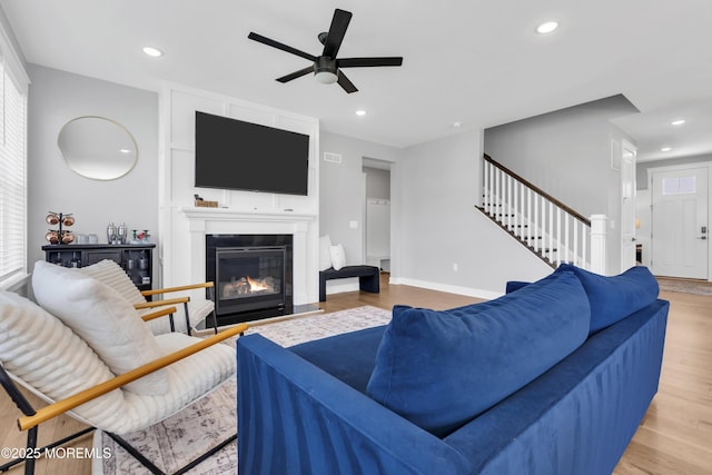 3 Devon Dr, Howell, NJ 07731 - living area featuring stairway, ceiling fan, light wood-style floors, a fireplace, and recessed lighting